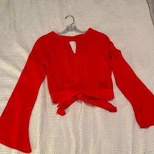 Beautiful open back crop shirt. It’s more of a hot pink than red/coral